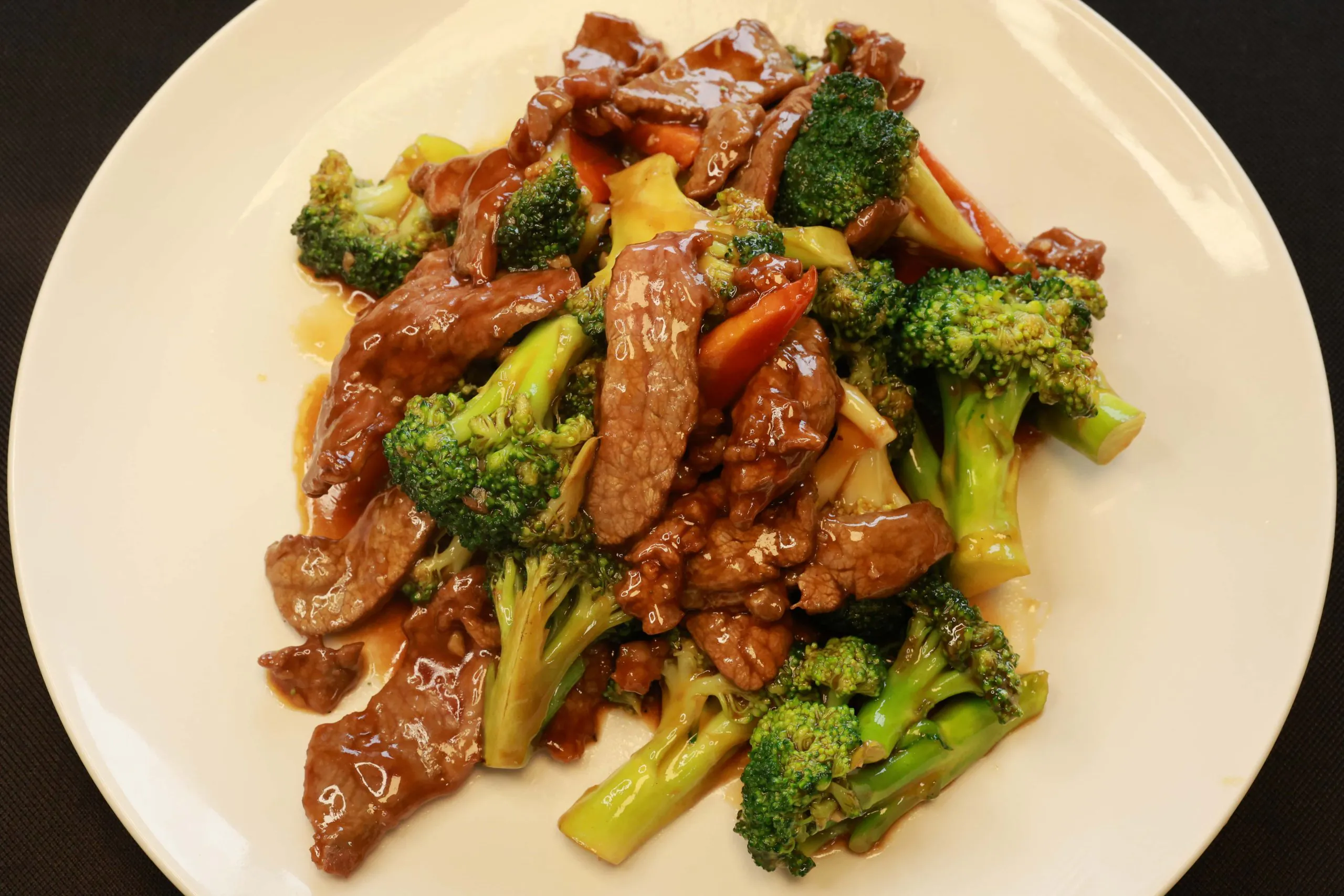 Tender beef stir-fried with fresh kale in savory sauce at Bao House, a Chinese Restaurant in Stillwater